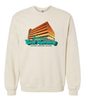 Image is a sand colored (crewneck sweatshirt with an image of the Division Street Parking Garage, a colorful parking garage in downtown East Lansing, on the front side. Beneath the garage, the text “Downtown East Lansing: Daytime. Nighttime. Anytime” is displayed.
